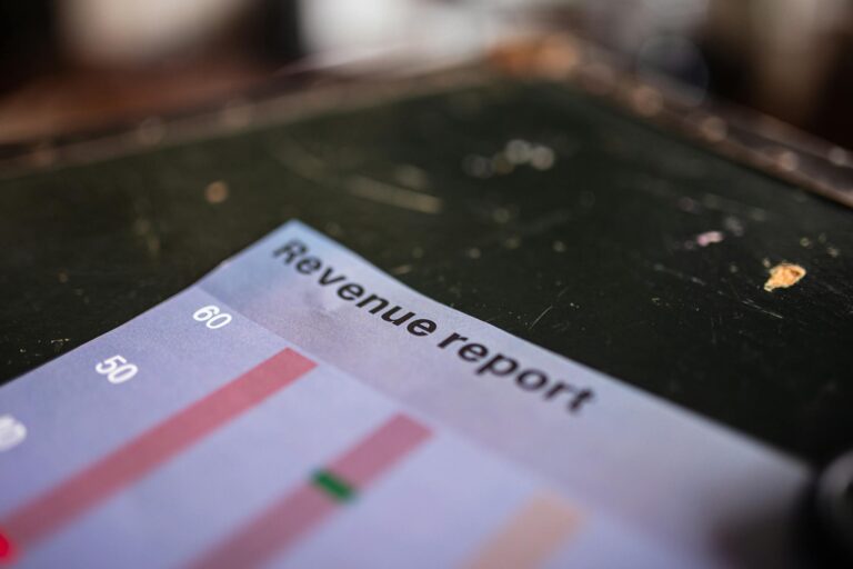 Detailed view of a revenue report featuring a bar chart in an office setting.